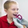 a boy chewing on textured grabber
